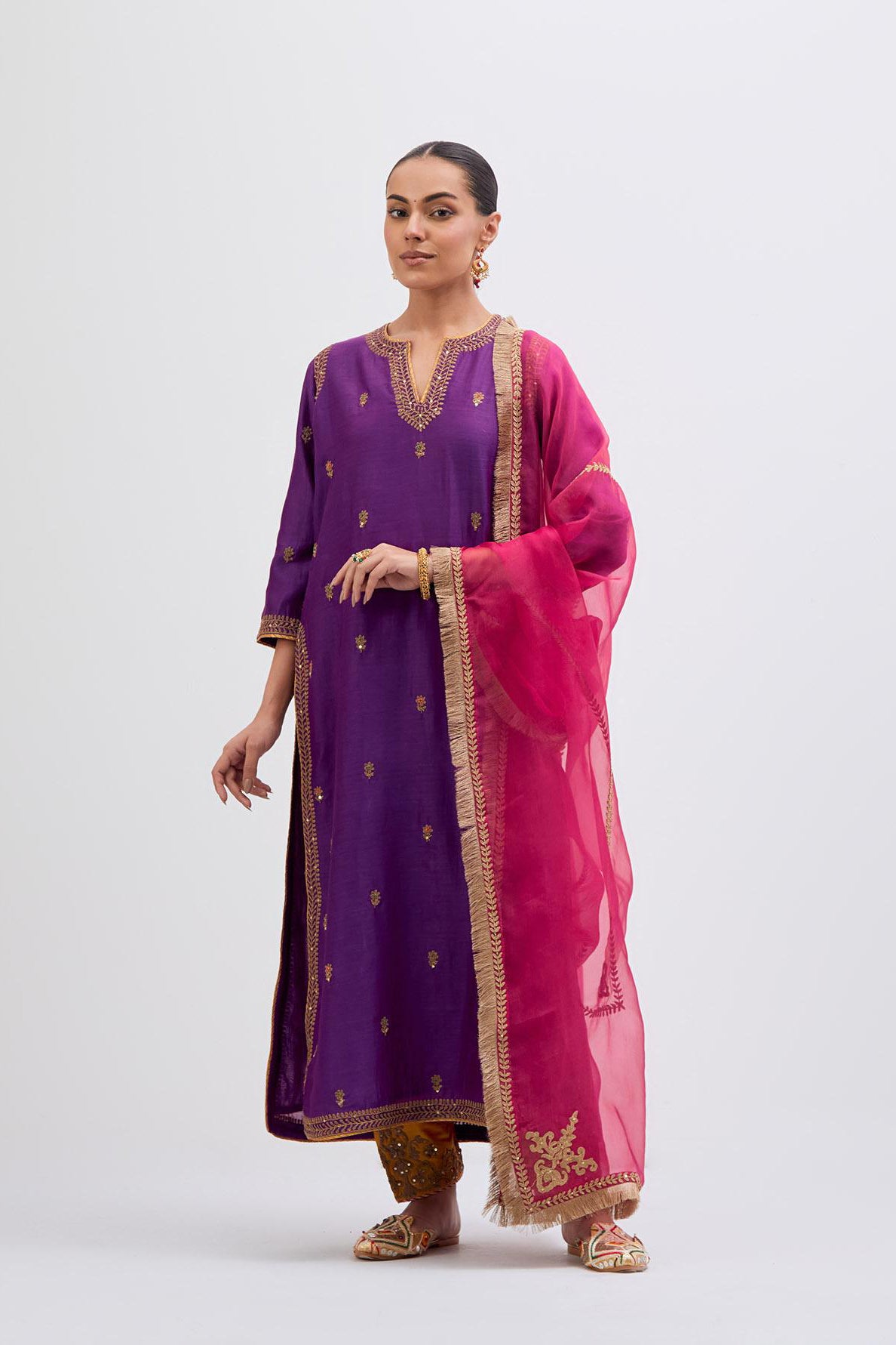 Purple Silk Chanderi straight kurta set with narrow border dull gold dori embroidery at front & back neck, sleeves, side slits and hem, highlighted with gold sequins and bead work.