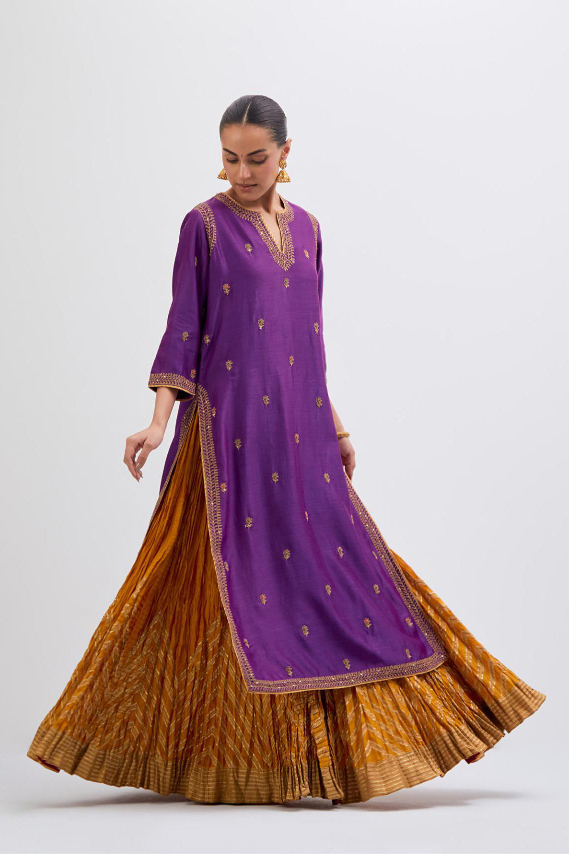 Purple Silk Chanderi straight kurta set with narrow border dull gold dori embroidery at front & back neck, sleeves, side slits and hem, highlighted with gold sequins and bead work.