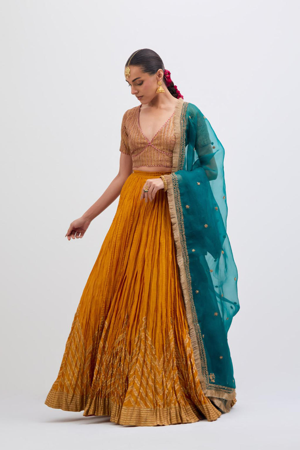 Yellow Silk Chanderi choli set with all-over gold gota work. It has a deep V neckline in the front, short sleeves and side zip.