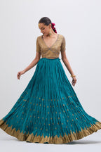 Blue Silk Chanderi choli set with all-over gold gota work. It has a deep V neckline in the front, short sleeves and side zip.