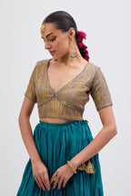Blue Silk Chanderi choli set with all-over gold gota work. It has a deep V neckline in the front, short sleeves and side zip.