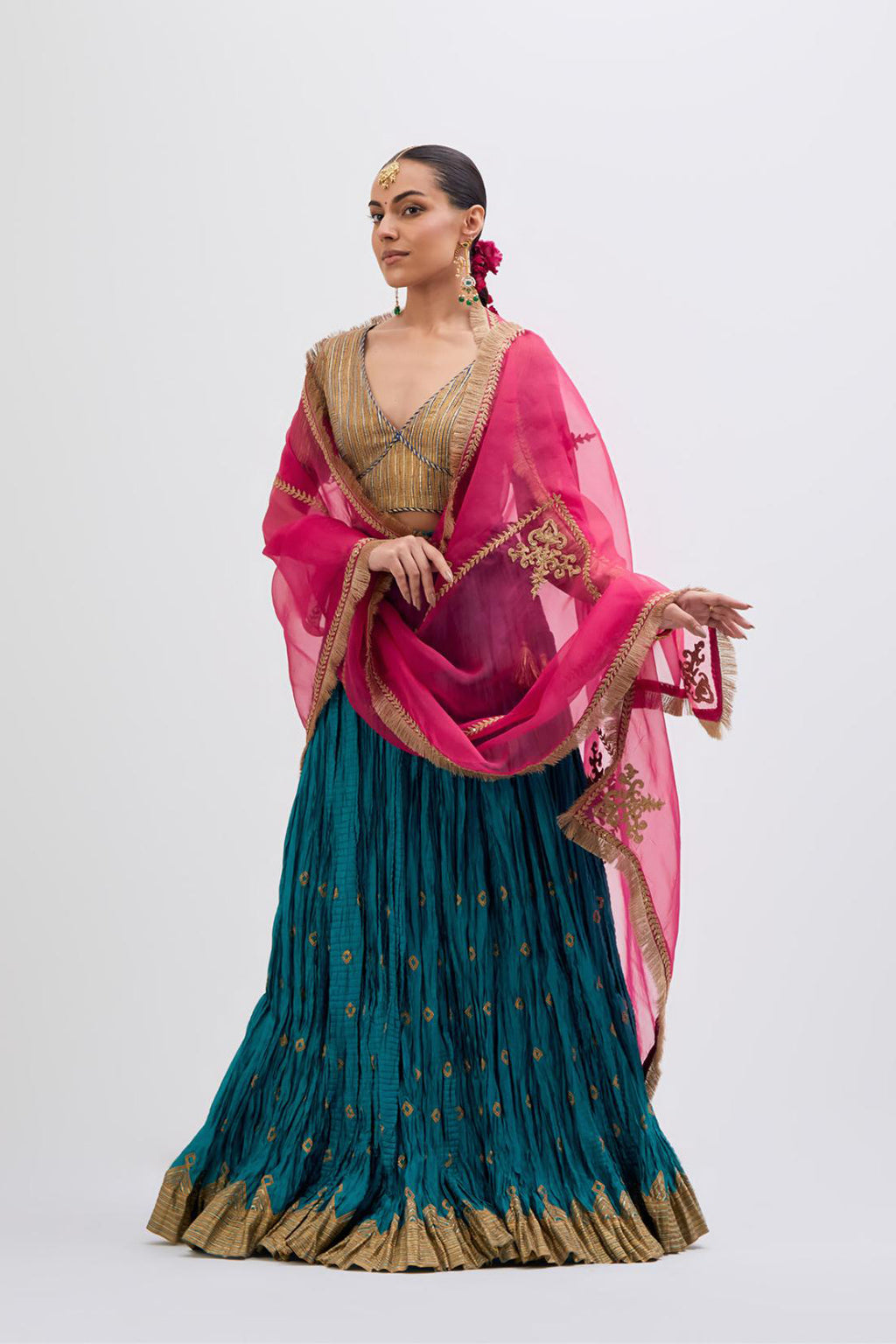 Blue Silk Chanderi choli set with all-over gold gota work. It has a deep V neckline in the front, short sleeves and side zip.