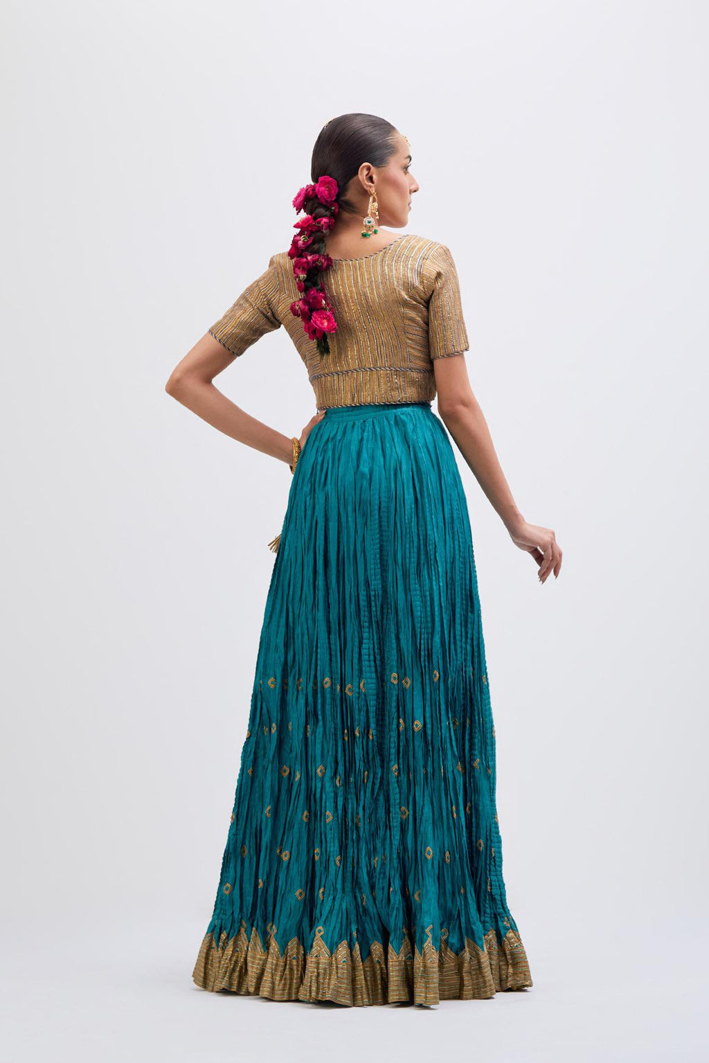 Blue Silk Chanderi choli set with all-over gold gota work. It has a deep V neckline in the front, short sleeves and side zip.