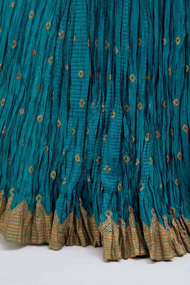 Chanderi 40 kali lehenga edged with dull gold gota embroidery and contrast chanderi facings.