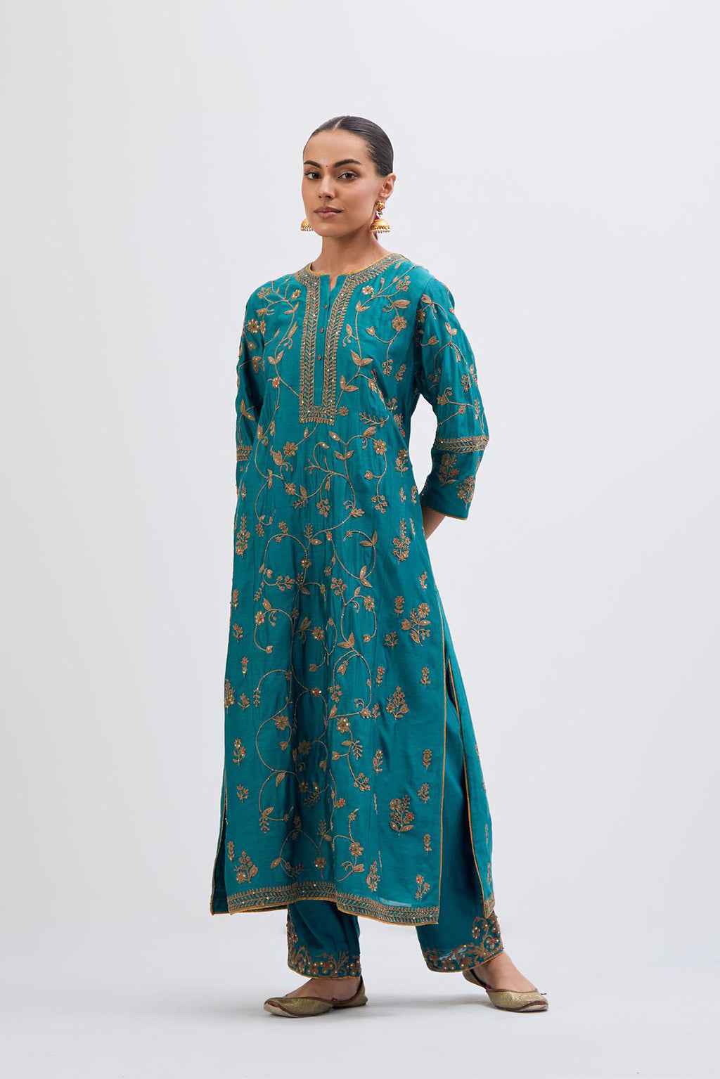 Teal Silk Chanderi kurta set with all-over dull gold dori jaal embroidery and small floral booti at side panels.