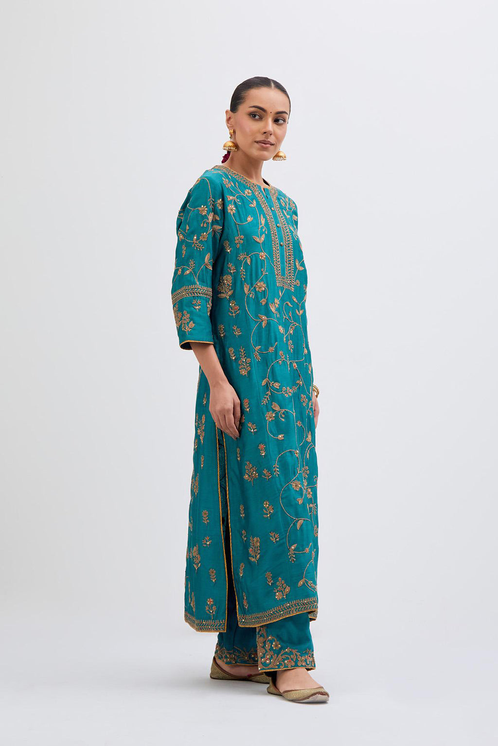 Teal Silk Chanderi kurta set with all-over dull gold dori jaal embroidery and small floral booti at side panels.