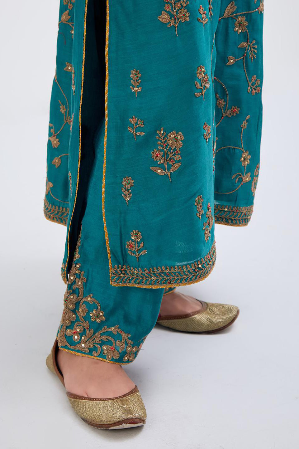Teal Silk Chanderi kurta set with all-over dull gold dori jaal embroidery and small floral booti at side panels.