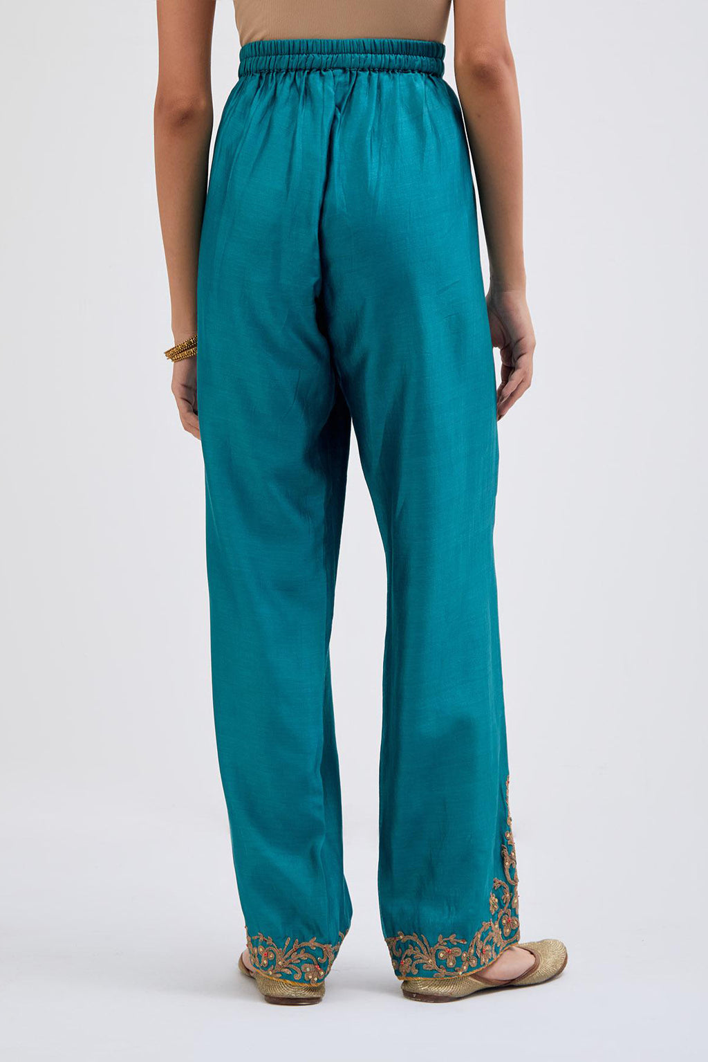 Teal Silk Chanderi pants with dull gold dori embroidery at hem, highlighted with multi colored beads and gold sequins work.