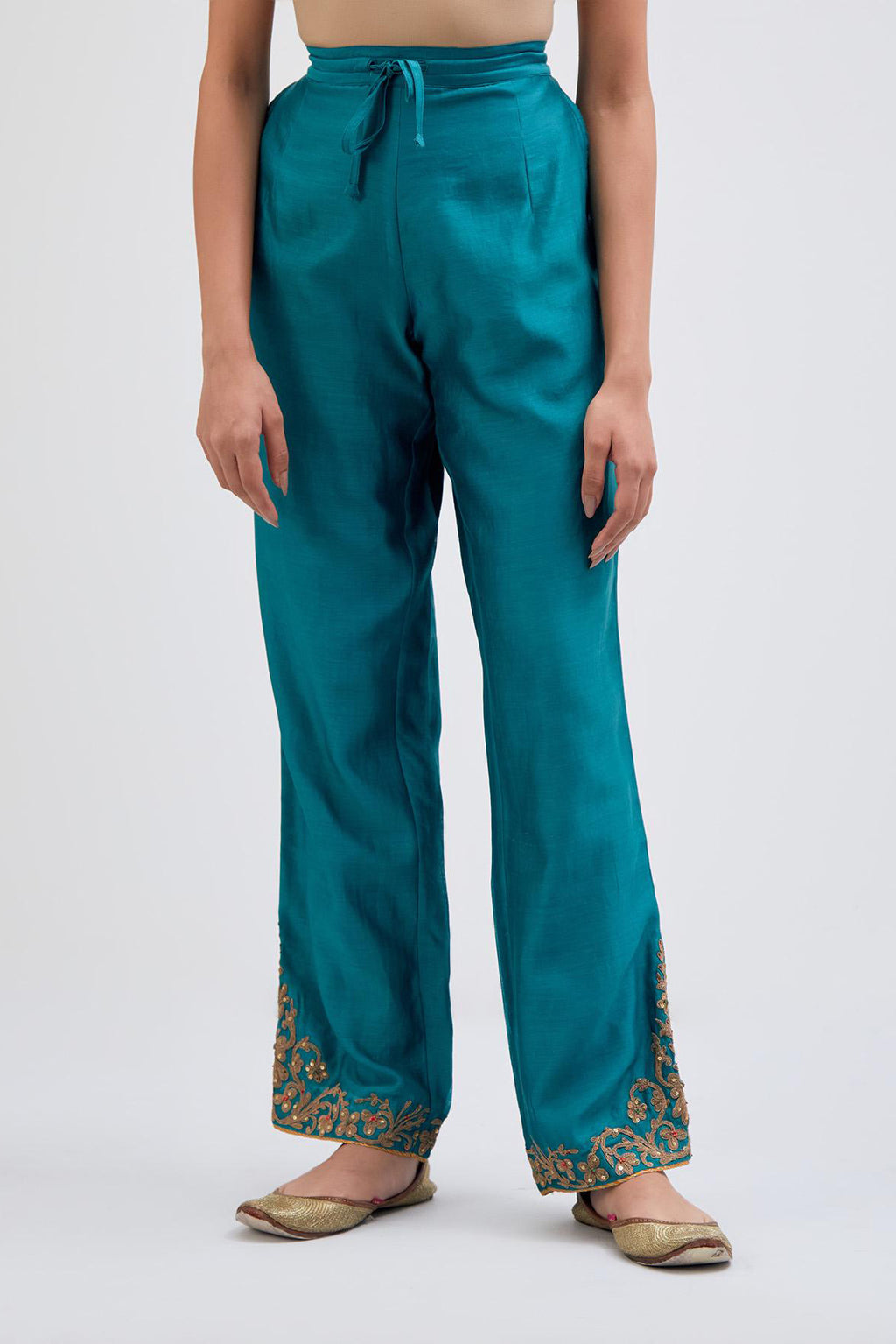 Teal Silk Chanderi pants with dull gold dori embroidery at hem, highlighted with multi colored beads and gold sequins work.