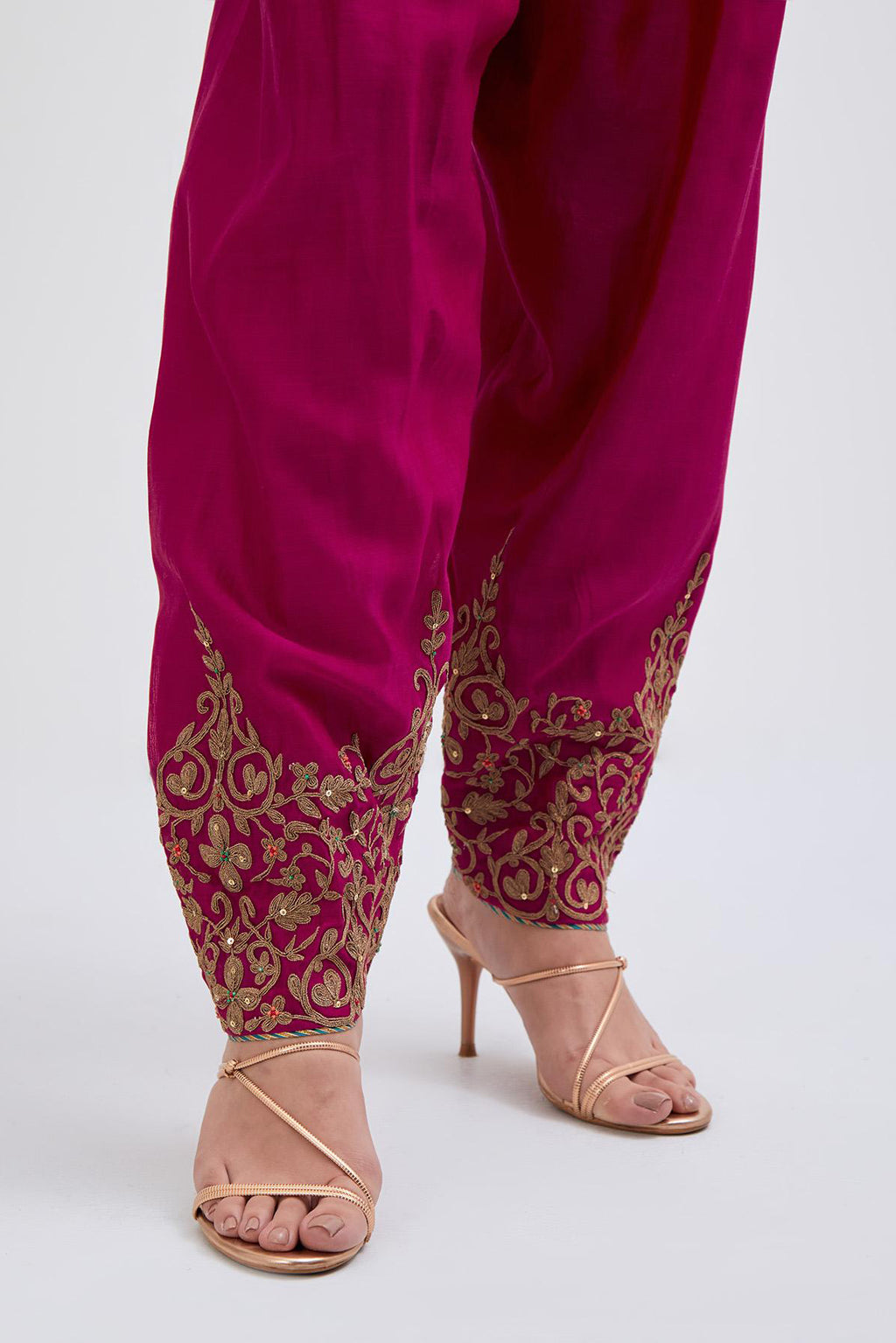 Deep Fuchsia Silk Chanderi narrow salwar with light gold dori embroidery at hem, highlighted with multi colored beads and gold sequins work.