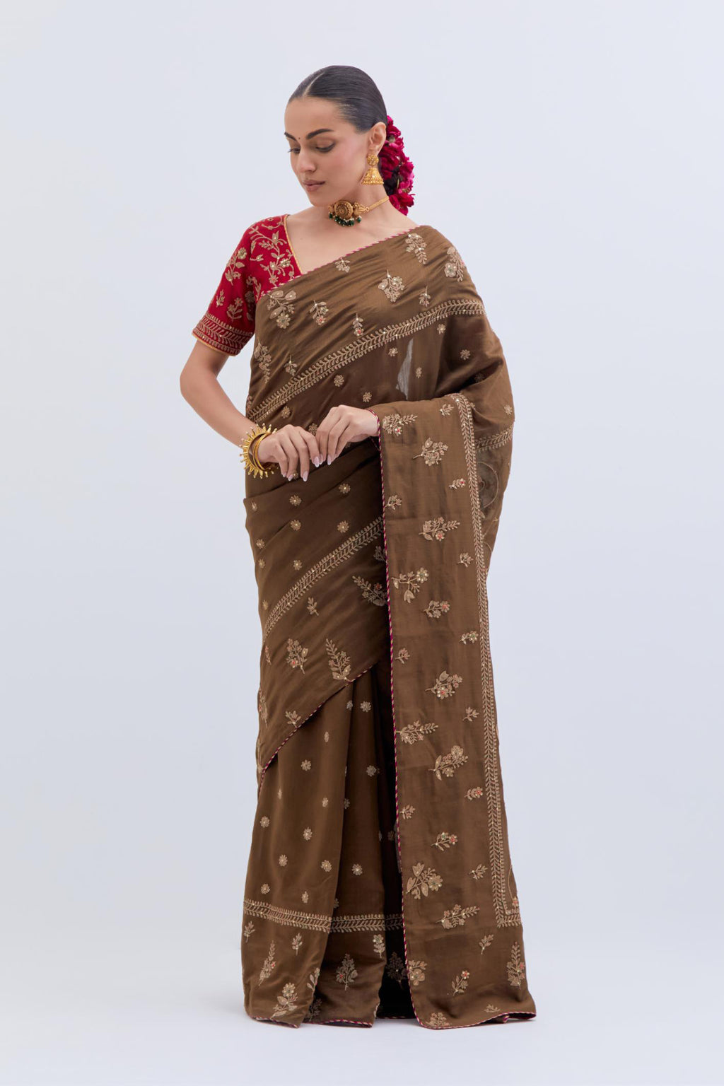 Olive Silk Chanderi saree with all-over dull gold dori embroidery, highlighted with multi colored beads and gold sequins, paired with Bright Red Silk Chanderi blouse with all-over dull gold dori embroidery.