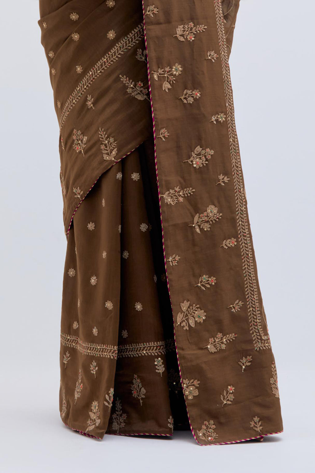 Olive Silk Chanderi saree with all-over dull gold dori embroidery, highlighted with multi colored beads and gold sequins, paired with Bright Red Silk Chanderi blouse with all-over dull gold dori embroidery.