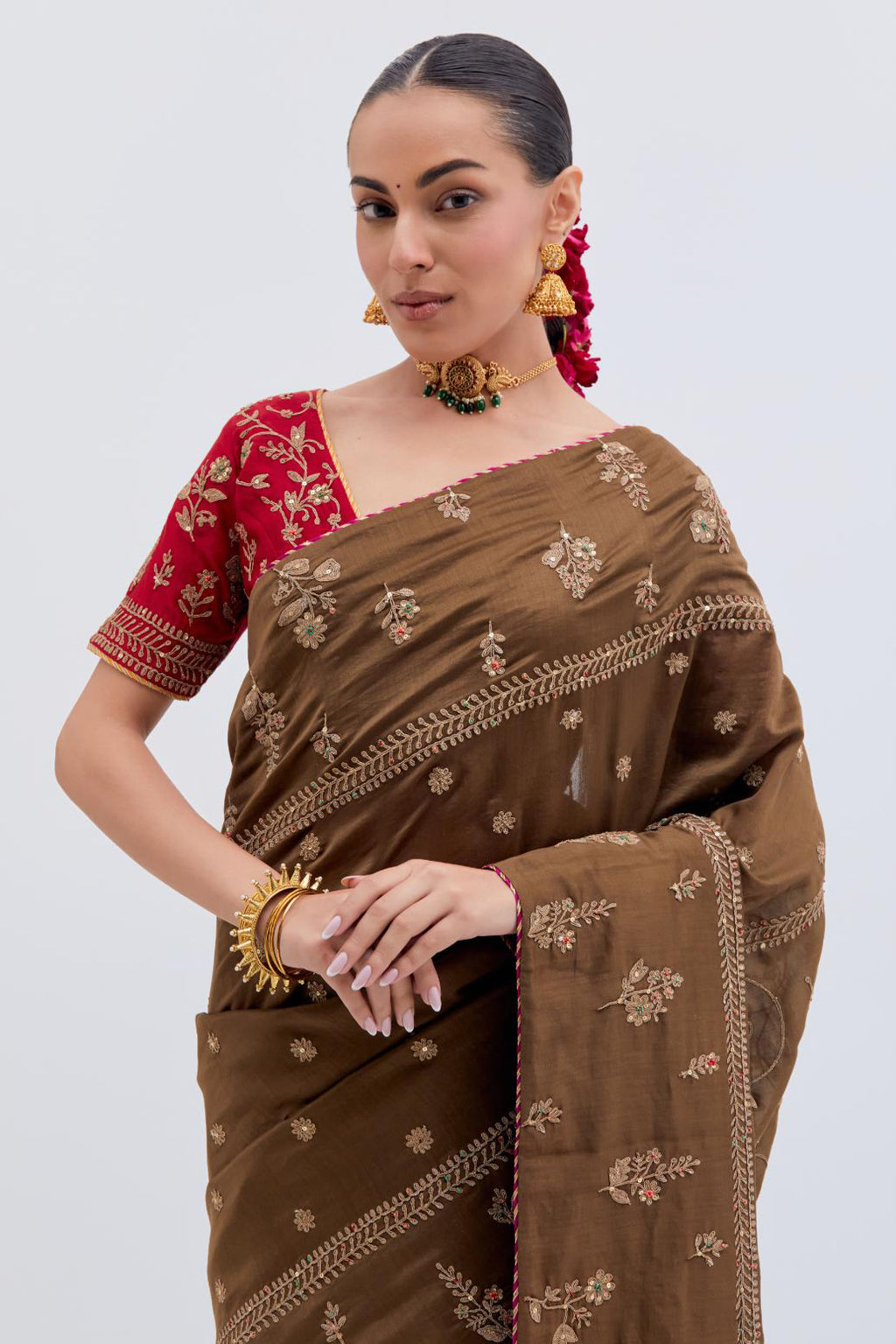 Olive Silk Chanderi saree with all-over dull gold dori embroidery, highlighted with multi colored beads and gold sequins, paired with Bright Red Silk Chanderi blouse with all-over dull gold dori embroidery.