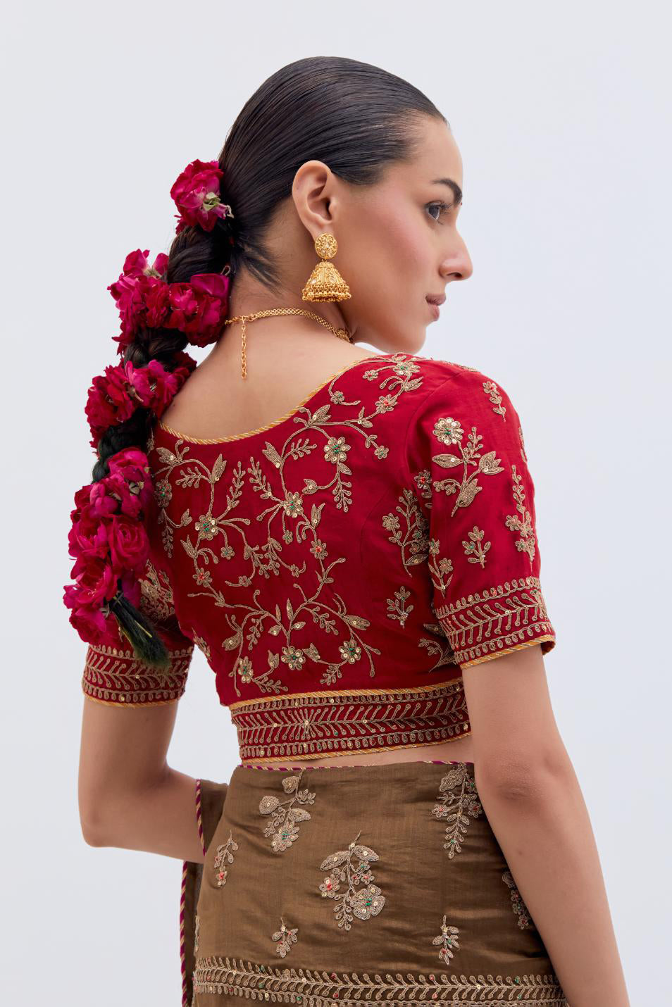 Olive Silk Chanderi saree with all-over dull gold dori embroidery, highlighted with multi colored beads and gold sequins, paired with Bright Red Silk Chanderi blouse with all-over dull gold dori embroidery.