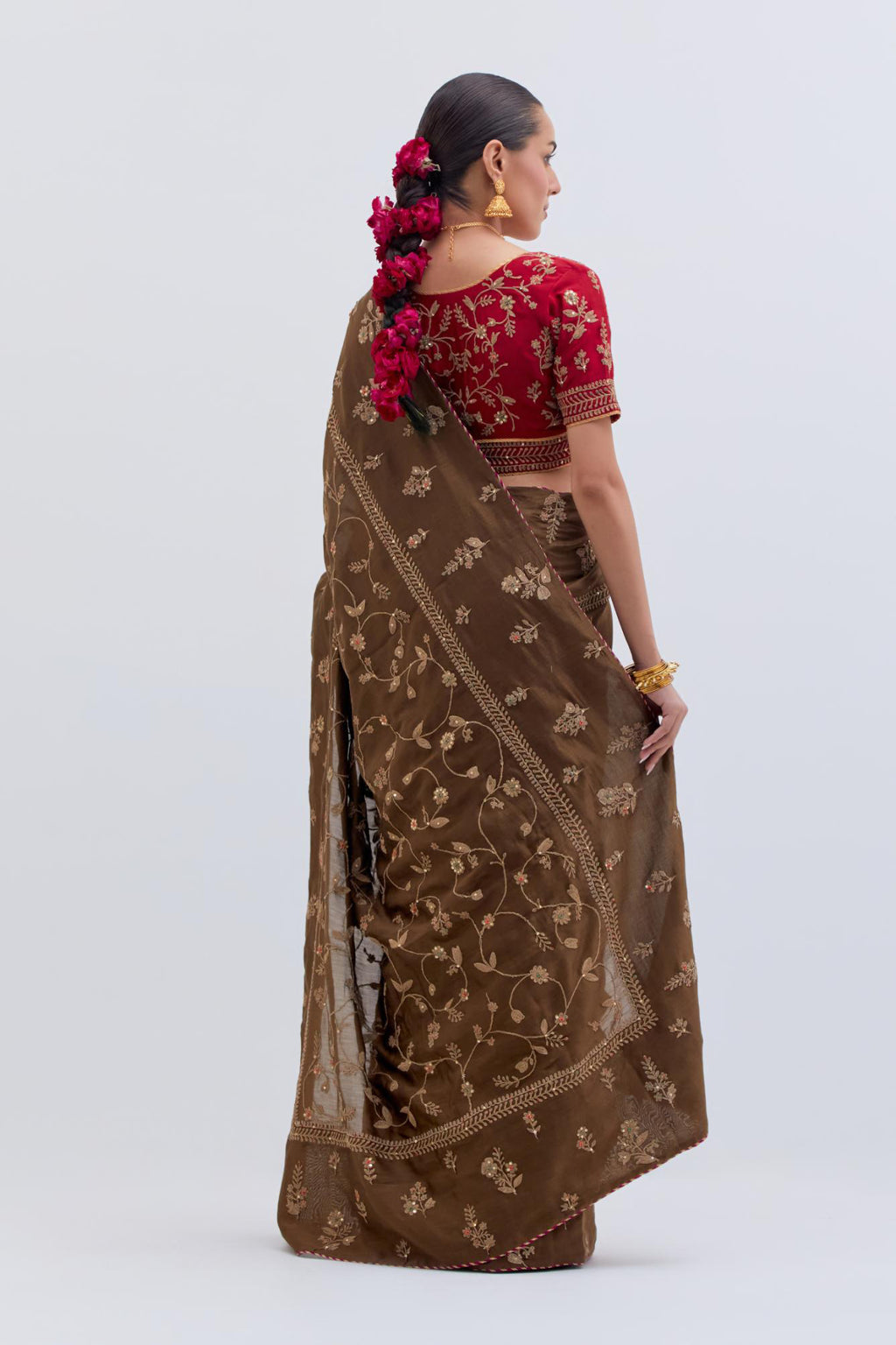 Olive Silk Chanderi saree with all-over dull gold dori embroidery, highlighted with multi colored beads and gold sequins, paired with Bright Red Silk Chanderi blouse with all-over dull gold dori embroidery.