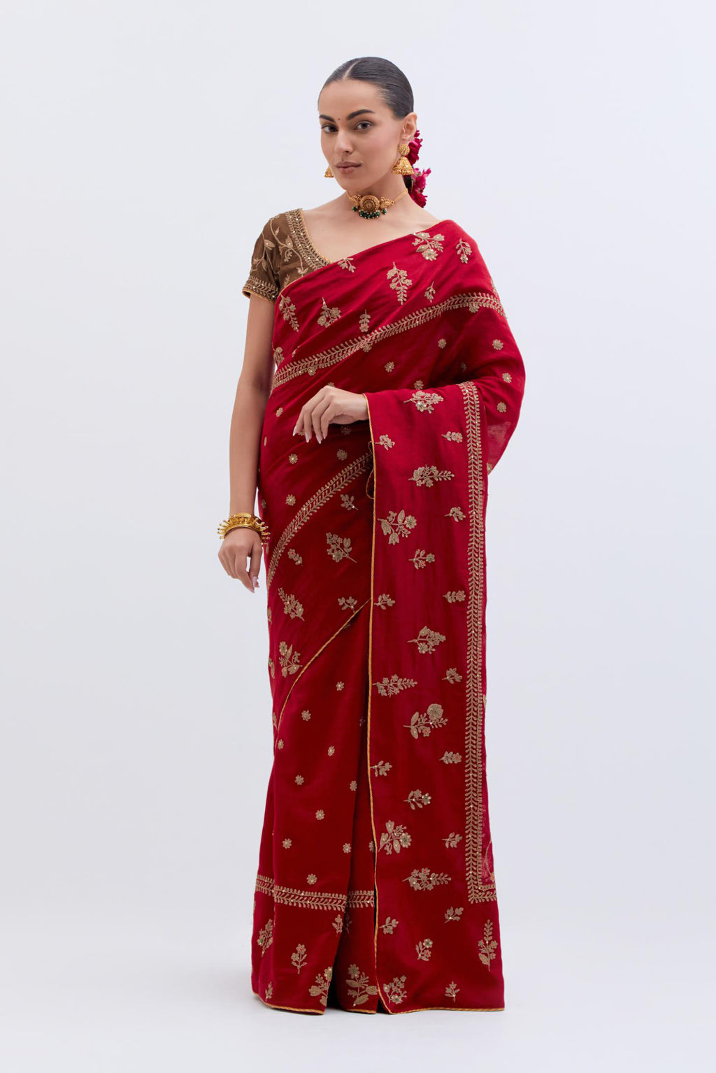 Bright Red Silk Chanderi saree with all-over dull gold dori embroidery, highlighted with multi colored beads and gold sequins, paired with Olive Silk Chanderi blouse with all-over dull gold dori embroidery.