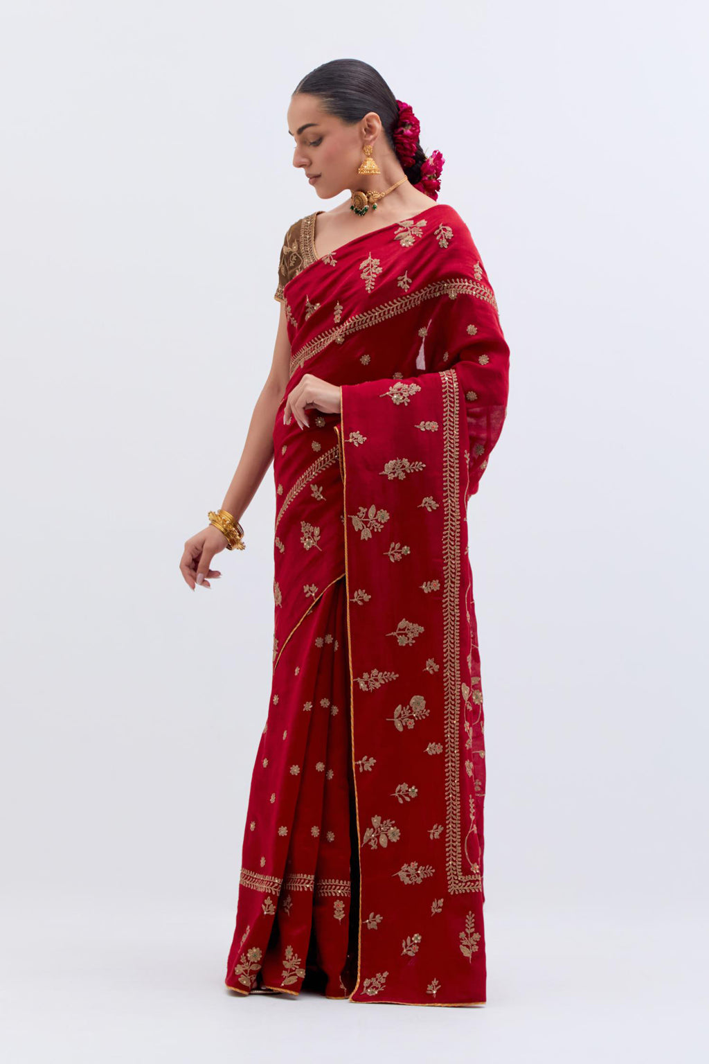 Bright Red Silk Chanderi saree with all-over dull gold dori embroidery, highlighted with multi colored beads and gold sequins, paired with Olive Silk Chanderi blouse with all-over dull gold dori embroidery.