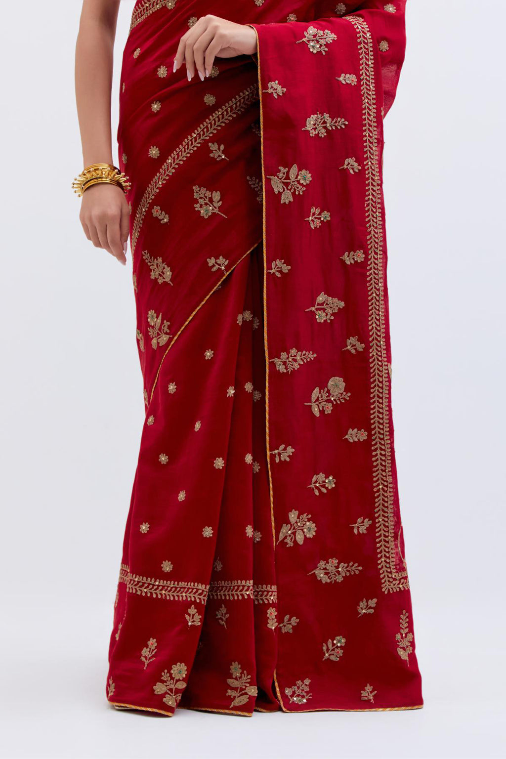 Bright Red Silk Chanderi saree with all-over dull gold dori embroidery, highlighted with multi colored beads and gold sequins, paired with Olive Silk Chanderi blouse with all-over dull gold dori embroidery.