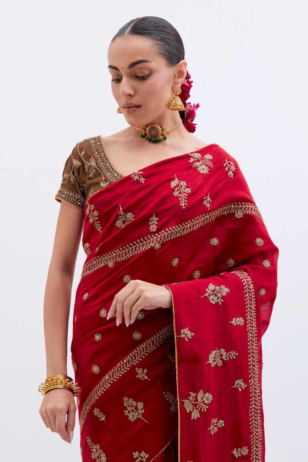 Bright Red Silk Chanderi saree with all-over dull gold dori embroidery, highlighted with multi colored beads and gold sequins, paired with Olive Silk Chanderi blouse with all-over dull gold dori embroidery.