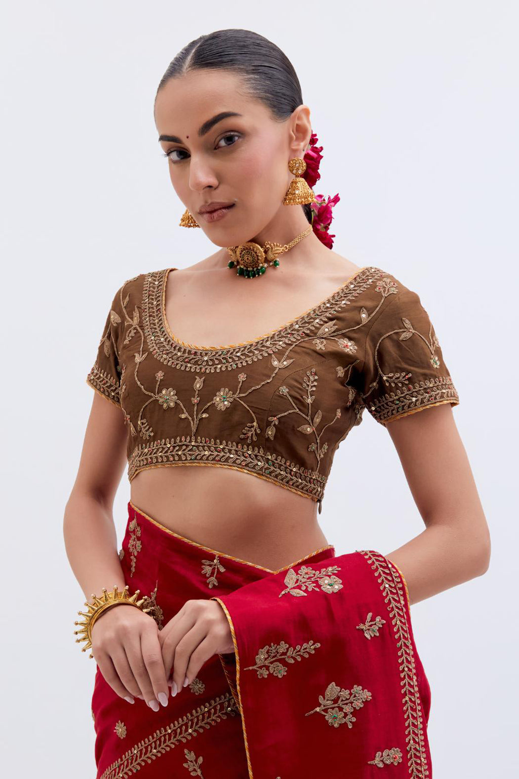 Bright Red Silk Chanderi saree with all-over dull gold dori embroidery, highlighted with multi colored beads and gold sequins, paired with Olive Silk Chanderi blouse with all-over dull gold dori embroidery.