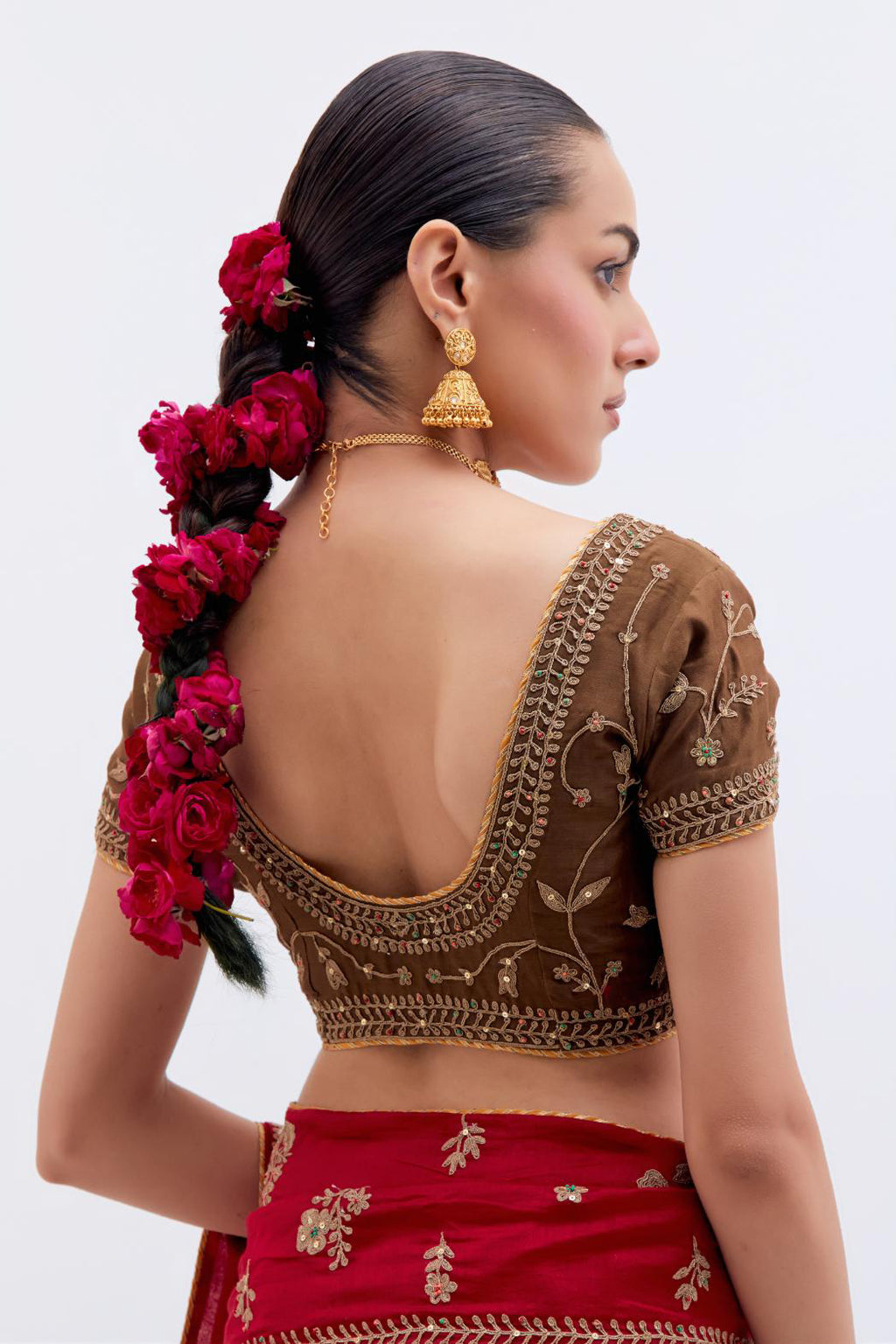 Bright Red Silk Chanderi saree with all-over dull gold dori embroidery, highlighted with multi colored beads and gold sequins, paired with Olive Silk Chanderi blouse with all-over dull gold dori embroidery.