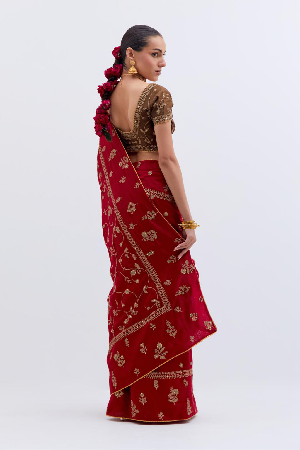 Bright Red Silk Chanderi saree with all-over dull gold dori embroidery, highlighted with multi colored beads and gold sequins, paired with Olive Silk Chanderi blouse with all-over dull gold dori embroidery.