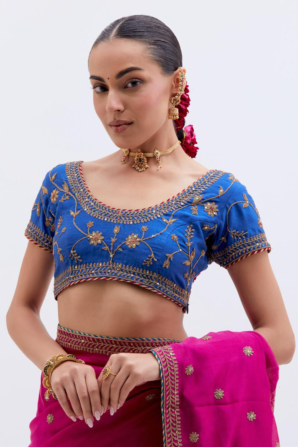 Fuchsia Silk Chanderi saree with all-over small floral dull gold dori booti embroidery, highlighted with multi colored beads and gold sequins work, paired with Chelsea Blue Silk Chanderi blouse with all-over dull gold dori embroidery.