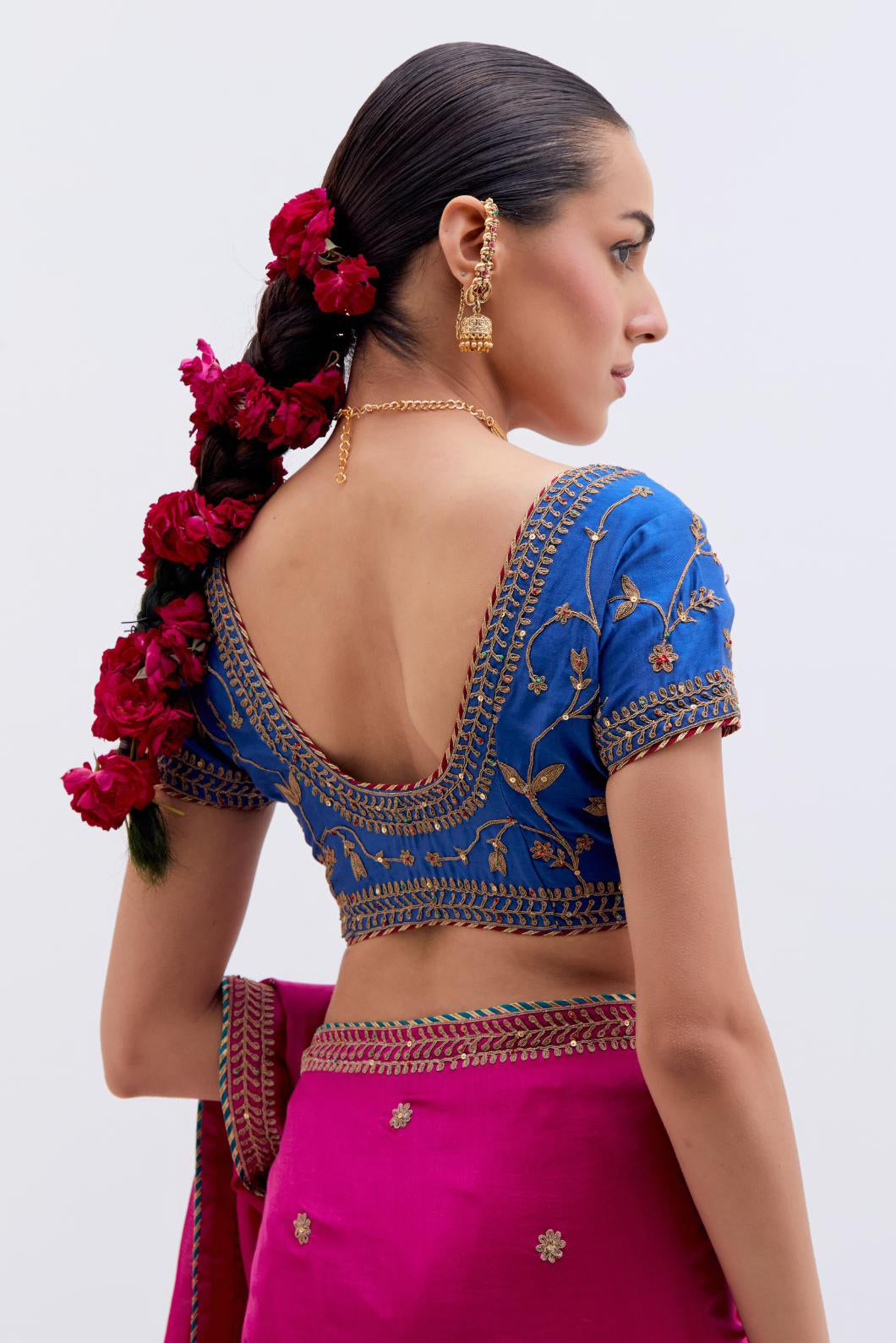 Fuchsia Silk Chanderi saree with all-over small floral dull gold dori booti embroidery, highlighted with multi colored beads and gold sequins work, paired with Chelsea Blue Silk Chanderi blouse with all-over dull gold dori embroidery.