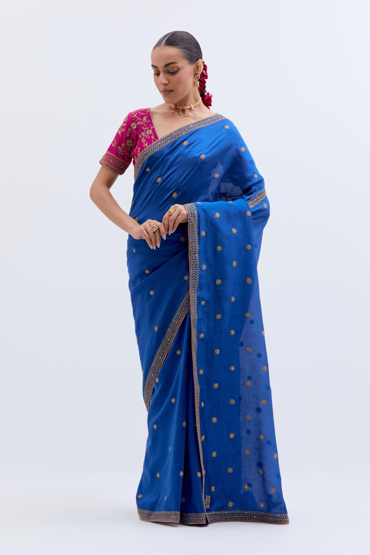 Chelsea Blue Silk Chanderi saree with all-over small floral dull gold dori booti embroidery, highlighted with multi colored beads and gold sequins work, paired with Fuchsia Silk Chanderi blouse with all-over dull gold dori embroidery.