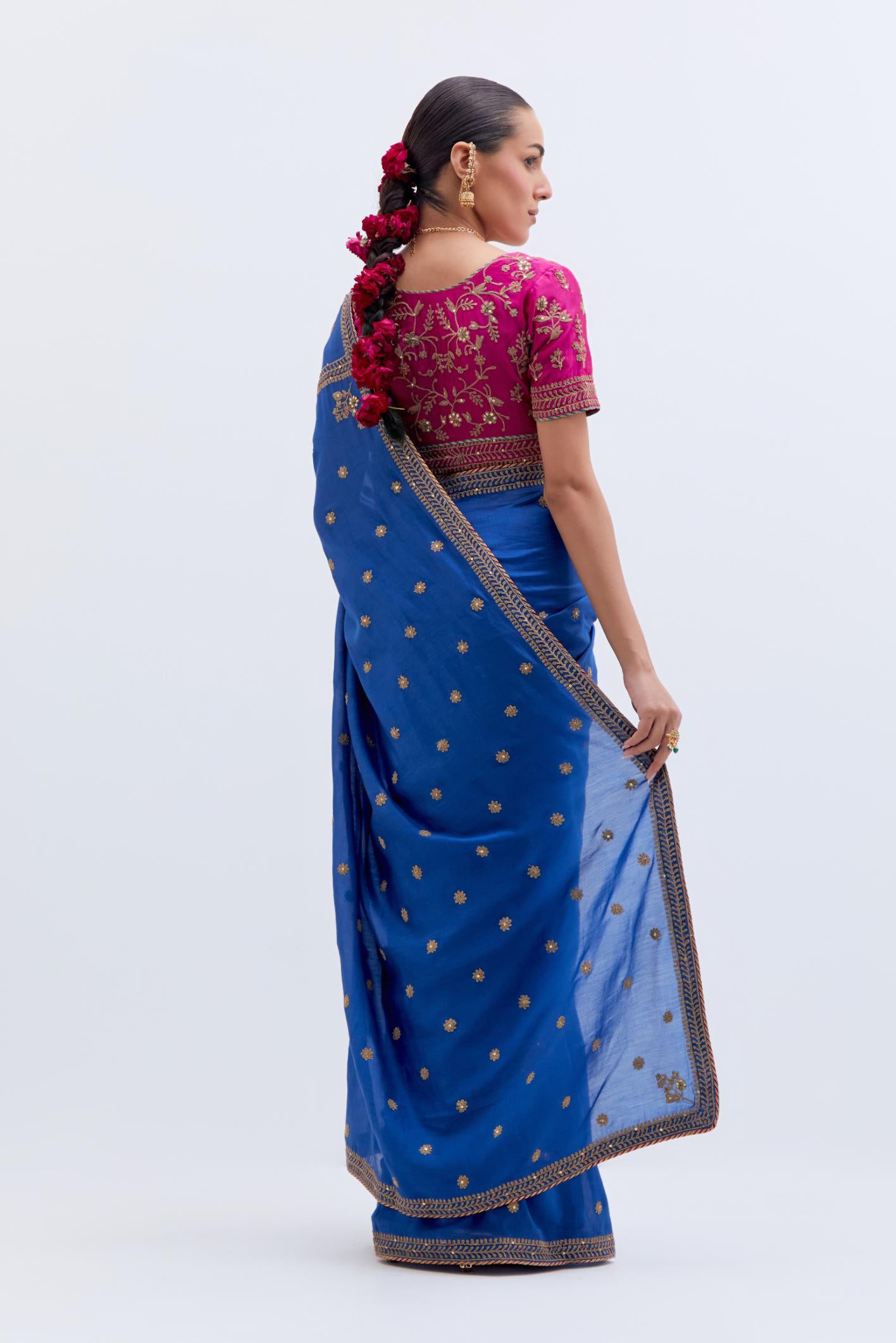 Chelsea Blue Silk Chanderi saree with all-over small floral dull gold dori booti embroidery, highlighted with multi colored beads and gold sequins work, paired with Fuchsia Silk Chanderi blouse with all-over dull gold dori embroidery.