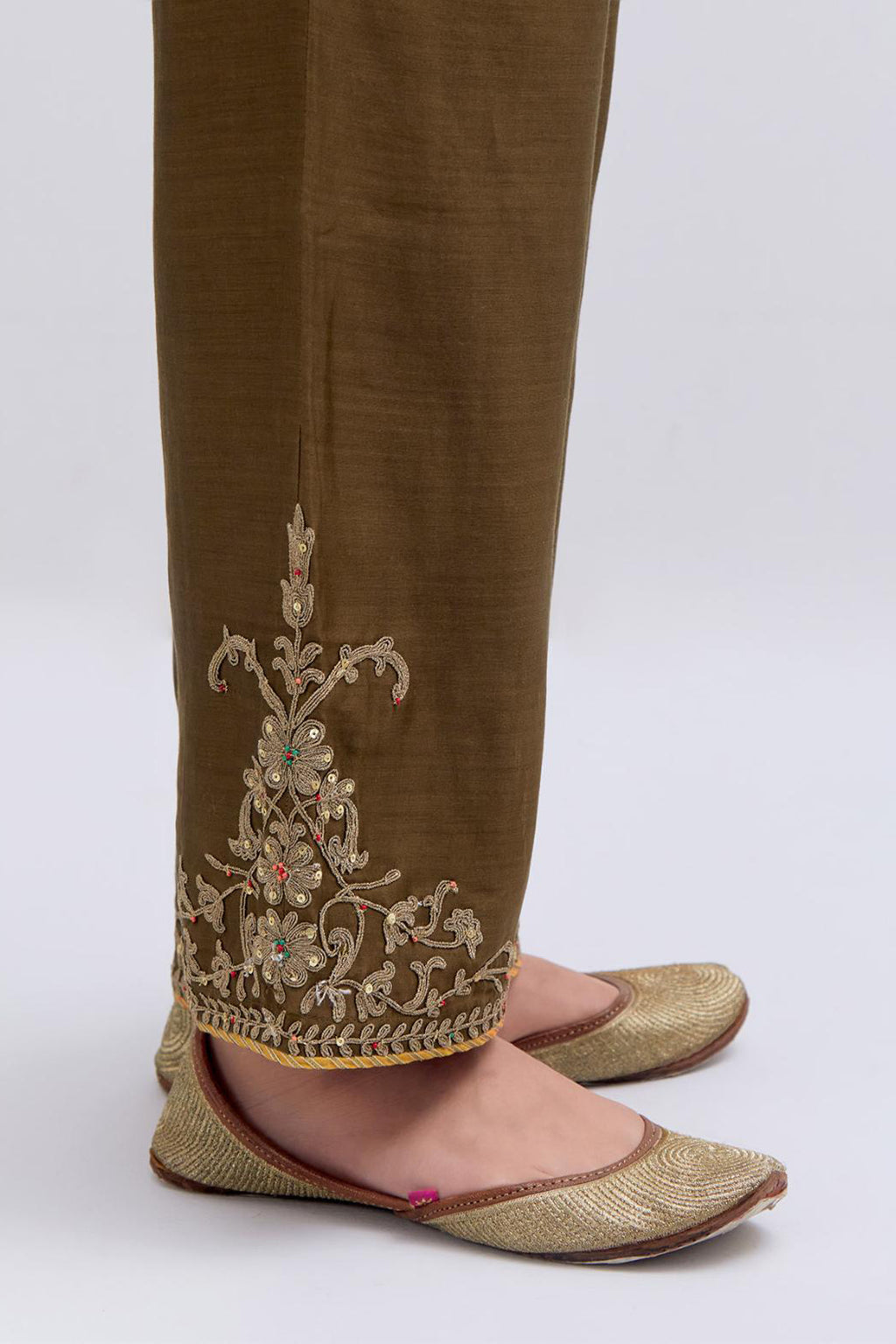 Olive Silk Chanderi pants with dull gold dori embroidery at hem, highlighted with multi colored beads and gold sequins work.