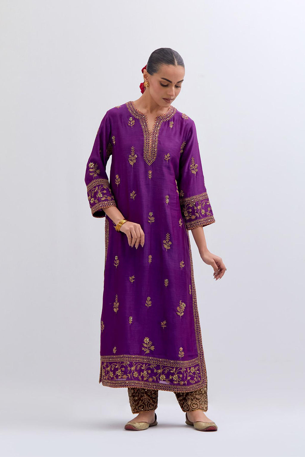 Purple Silk Chanderi straight kurta set with dull gold dori embroidery at front & back neck, sleeves, side slits and hem, highlighted with gold sequins and bead work.