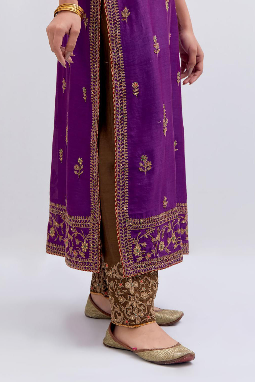 Purple Silk Chanderi straight kurta set with dull gold dori embroidery at front & back neck, sleeves, side slits and hem, highlighted with gold sequins and bead work.