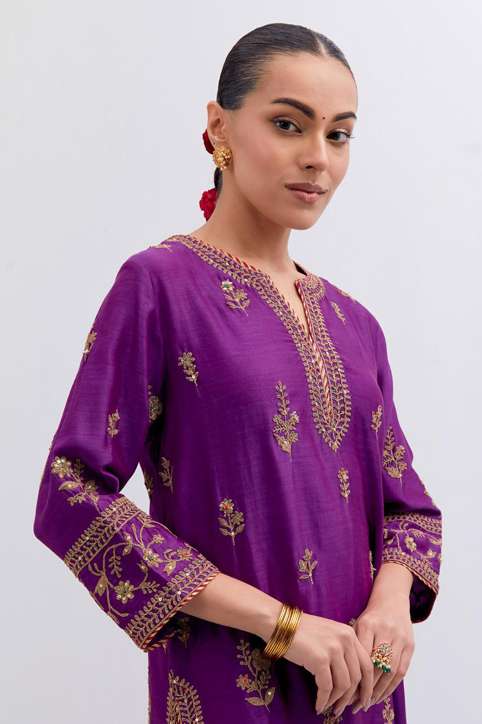 Purple Silk Chanderi straight kurta set with dull gold dori embroidery at front & back neck, sleeves, side slits and hem, highlighted with gold sequins and bead work.