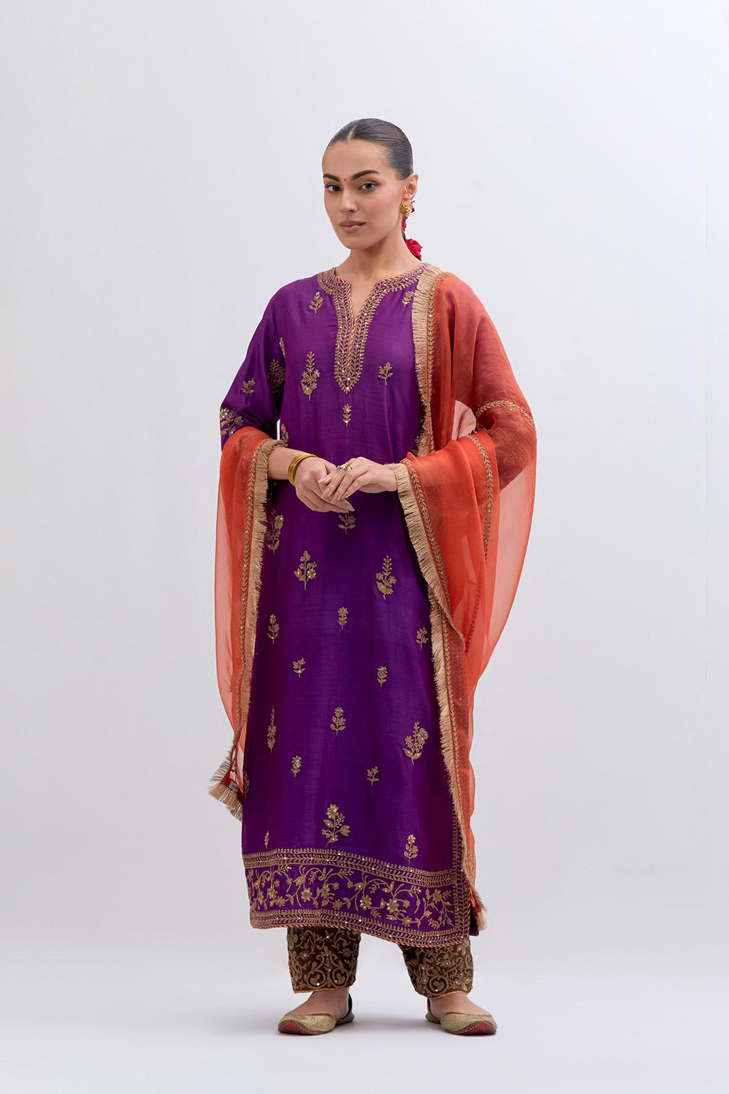 Purple Silk Chanderi straight kurta set with dull gold dori embroidery at front & back neck, sleeves, side slits and hem, highlighted with gold sequins and bead work.
