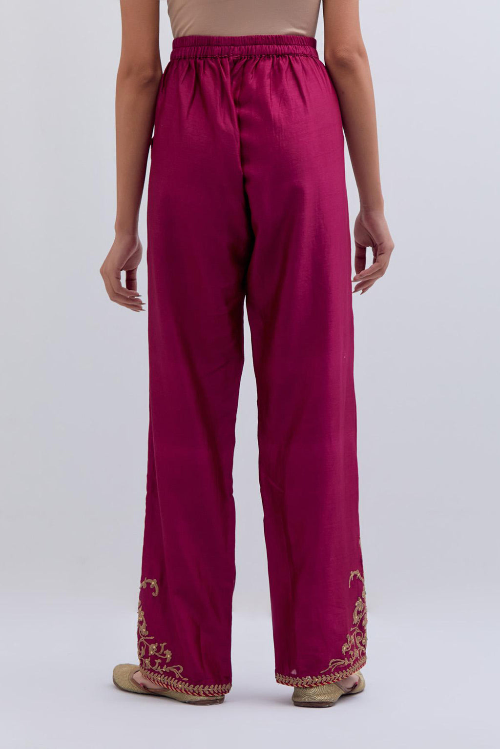 Deep fuchsia Silk Chanderi pants with dull gold dori embroidery at hem, highlighted with multi colored beads and gold sequins work.