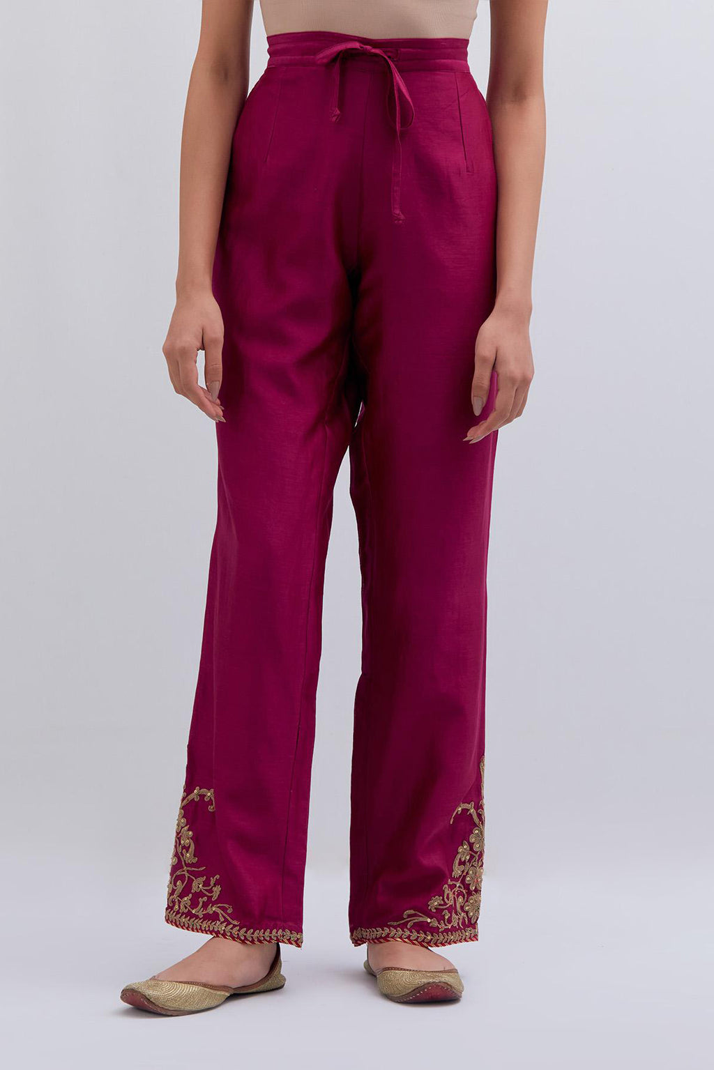 Deep fuchsia Silk Chanderi pants with dull gold dori embroidery at hem, highlighted with multi colored beads and gold sequins work.