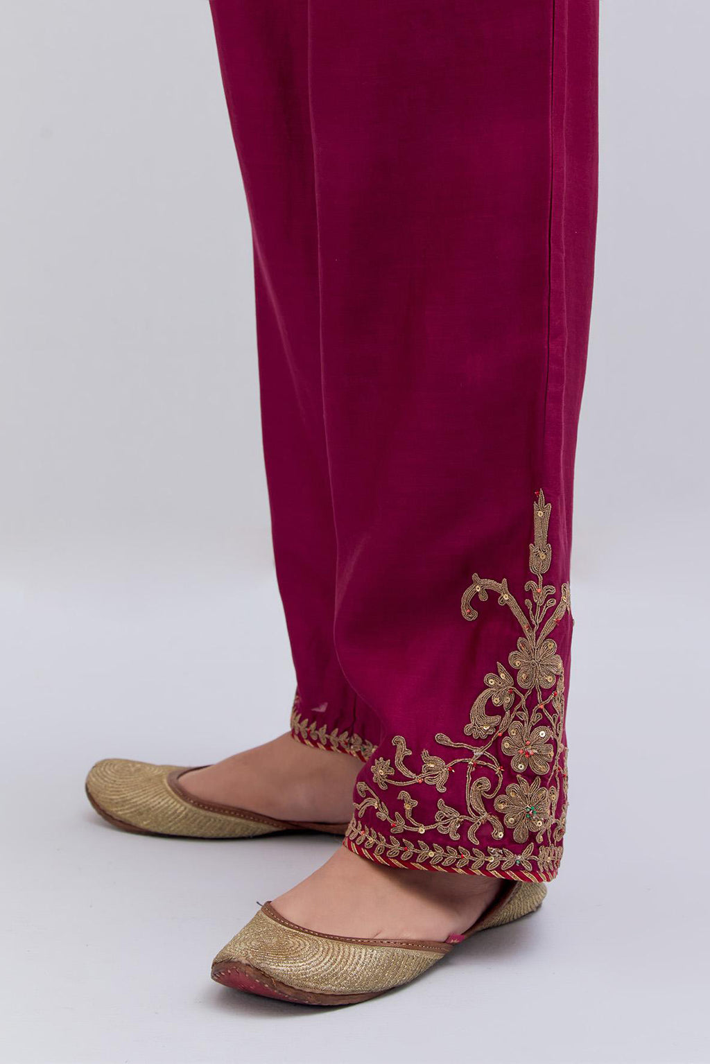 Deep fuchsia Silk Chanderi pants with dull gold dori embroidery at hem, highlighted with multi colored beads and gold sequins work.