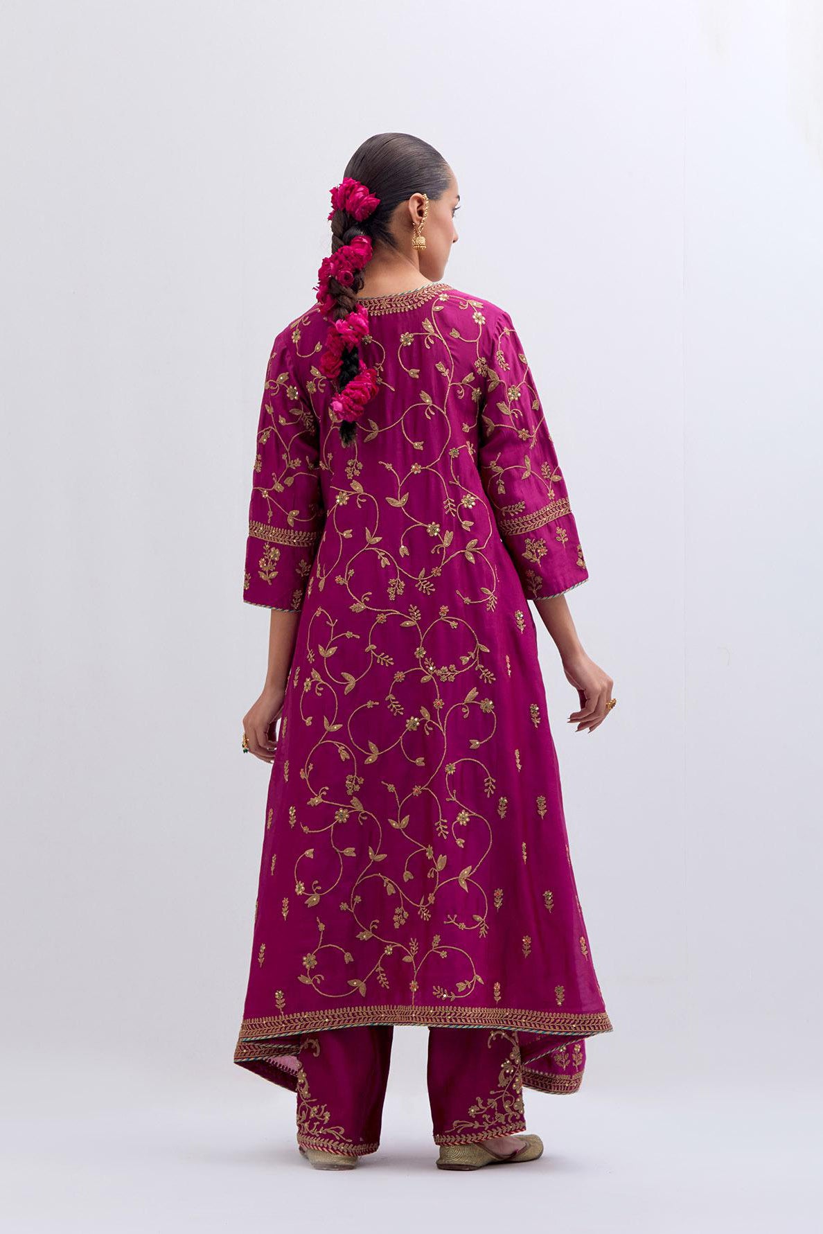 Deep Fuchsia Silk Chanderi kurta set with asymmetric hem and all-over dull gold dori embroidery, highlighted with multi colored beads and gold sequins.
