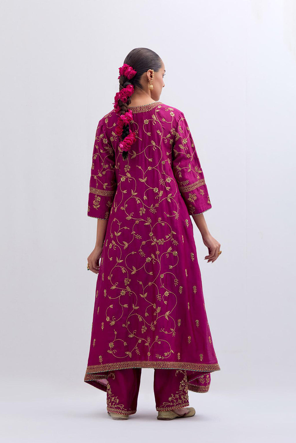 Deep Fuchsia Silk Chanderi kurta set with asymmetric hem and all-over dull gold dori embroidery, highlighted with multi colored beads and gold sequins.