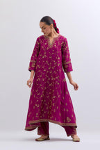 Deep Fuchsia Silk Chanderi kurta set with asymmetric hem and all-over dull gold dori embroidery, highlighted with multi colored beads and gold sequins.