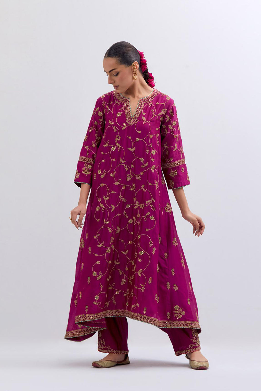 Deep Fuchsia Silk Chanderi kurta set with asymmetric hem and all-over dull gold dori embroidery, highlighted with multi colored beads and gold sequins.
