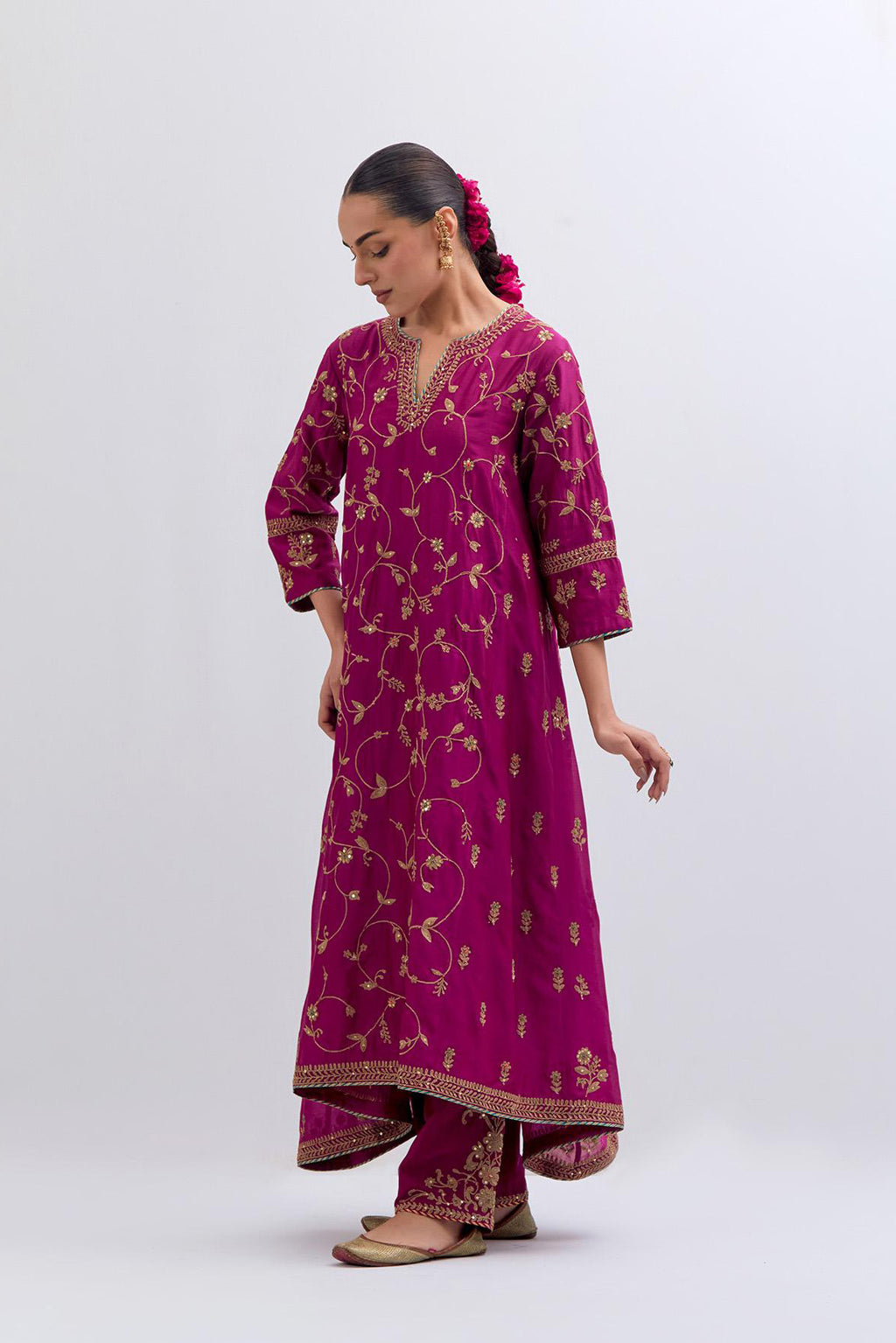 Deep Fuchsia Silk Chanderi kurta set with asymmetric hem and all-over dull gold dori embroidery, highlighted with multi colored beads and gold sequins.