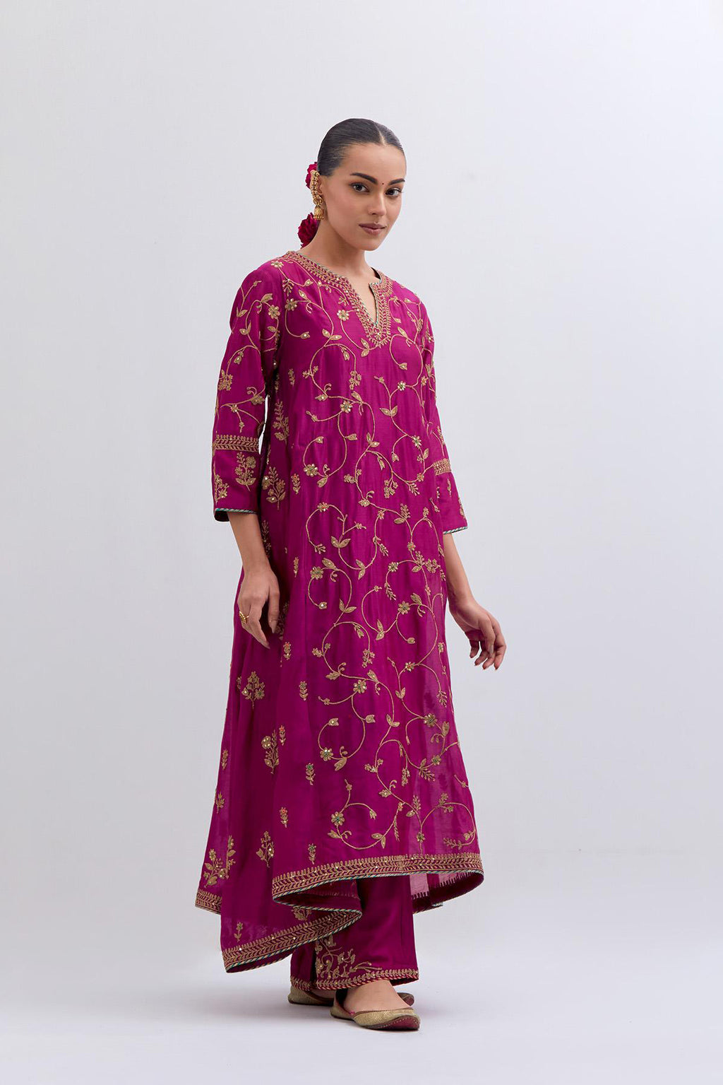 Deep Fuchsia Silk Chanderi kurta set with asymmetric hem and all-over dull gold dori embroidery, highlighted with multi colored beads and gold sequins.