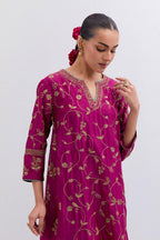 Deep Fuchsia Silk Chanderi kurta set with asymmetric hem and all-over dull gold dori embroidery, highlighted with multi colored beads and gold sequins.