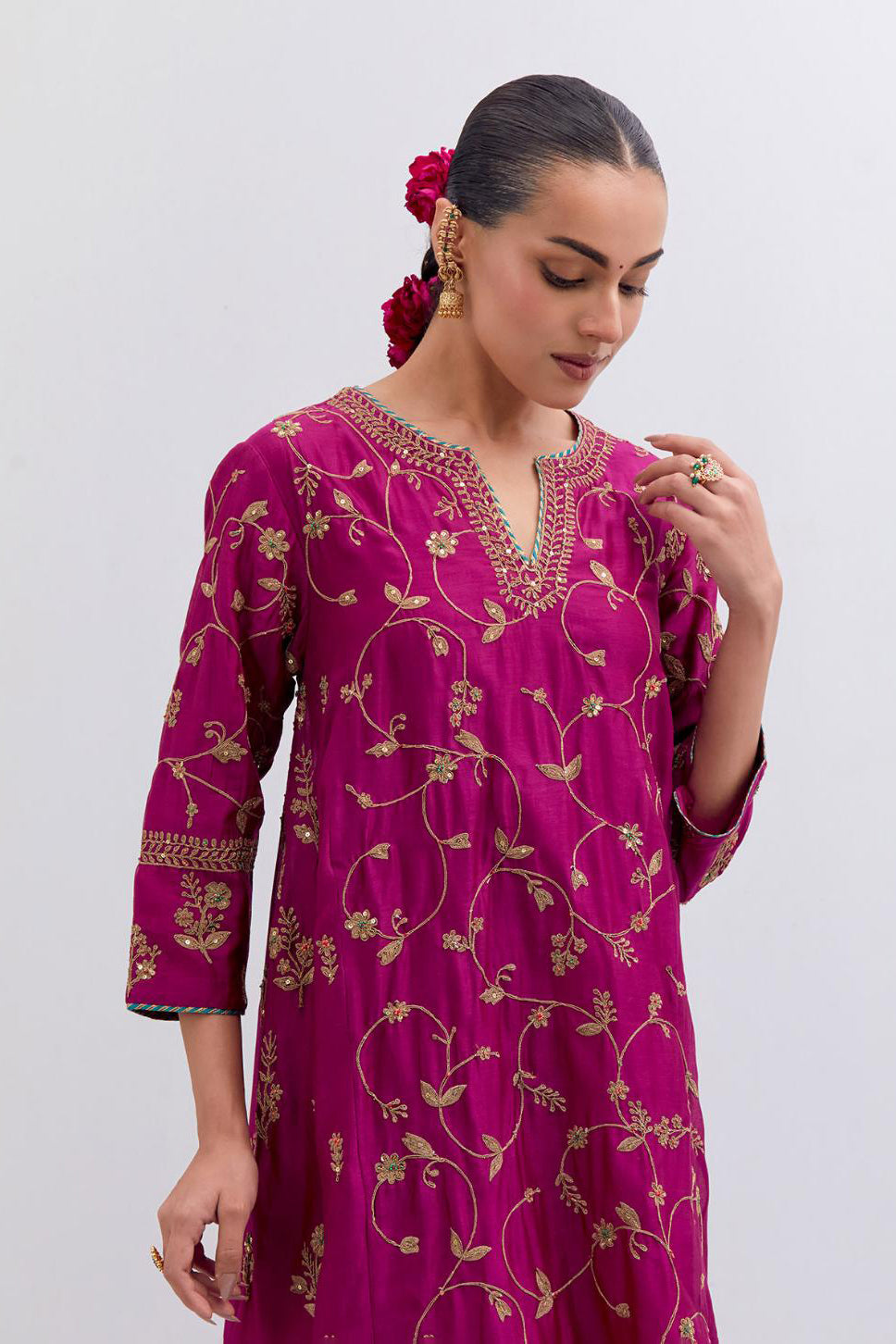 Deep Fuchsia Silk Chanderi kurta set with asymmetric hem and all-over dull gold dori embroidery, highlighted with multi colored beads and gold sequins.