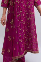 Deep Fuchsia Silk Chanderi kurta set with asymmetric hem and all-over dull gold dori embroidery, highlighted with multi colored beads and gold sequins.