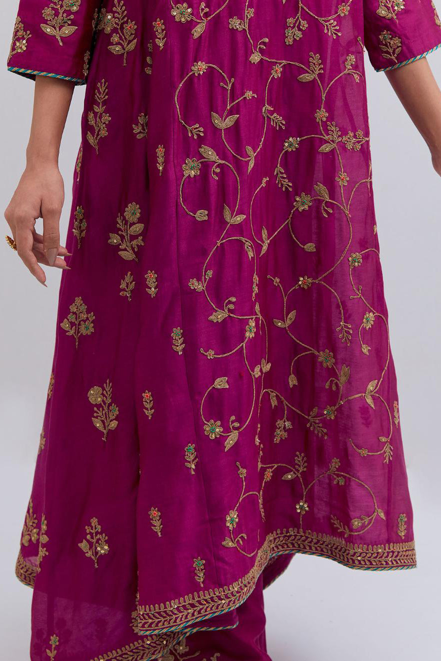 Deep Fuchsia Silk Chanderi kurta set with asymmetric hem and all-over dull gold dori embroidery, highlighted with multi colored beads and gold sequins.