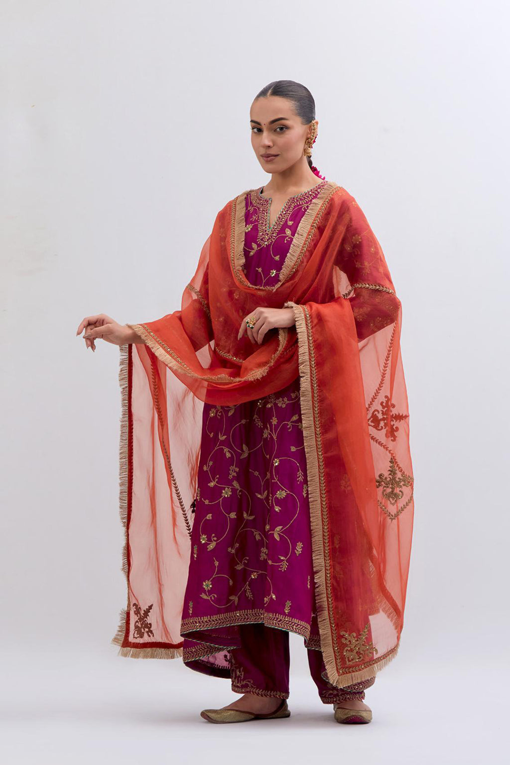 Deep Fuchsia Silk Chanderi kurta set with asymmetric hem and all-over dull gold dori embroidery, highlighted with multi colored beads and gold sequins.