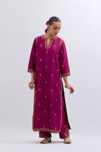 Fuchsia Silk Chanderi straight kurta set with narrow border dull gold dori embroidery at front & back neck, sleeves, side slits and hem, highlighted with gold sequins and bead work.
